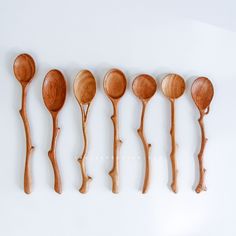 six wooden spoons lined up next to each other