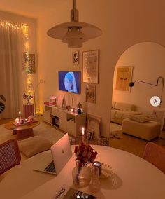 a laptop computer sitting on top of a table in a living room next to a couch