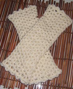 a white crocheted scarf laying on top of a bamboo mat