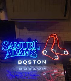 a neon sign that says samuel adams's boston, and a pair of shoes