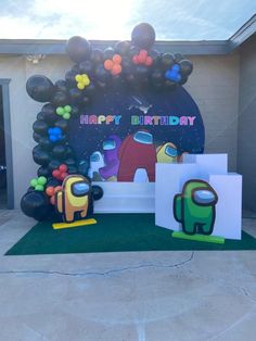 an outdoor birthday party with balloons and decorations