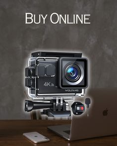 an image of a camera and laptop on a table with the words buy online above it