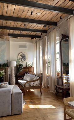 a living room filled with furniture and lots of windows