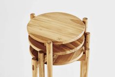 three wooden stools stacked on top of each other