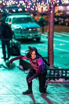 a woman is skating on the sidewalk in the snow