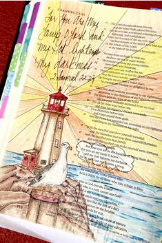 an open bible with a drawing of a lighthouse on the top and words above it