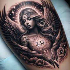 a woman's arm with an angel tattoo on it and the number 33 in her hand