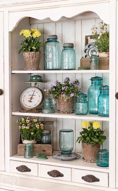 the shelves are filled with vases and flowers