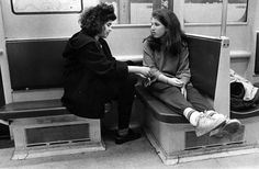 two women sitting on a train next to each other