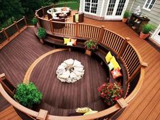 an outdoor deck with seating and fire pit