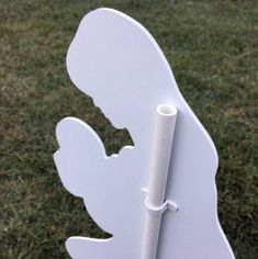 a close up of a white chair with a stick sticking out of it