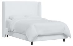 a bed with white linens and pillows on top of the headboard, in front of a white background