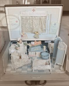 an old fashioned doll house with furniture and accessories