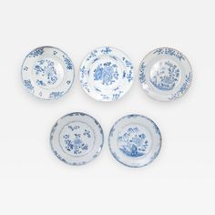 four blue and white plates sitting on top of each other