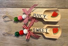 two wooden spoons decorated with watermelon slices and the words juicy, sweet on them