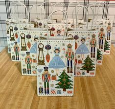 four paper bags decorated with nutcrackers, princesses and christmas tree decorations