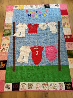 a quilted wall hanging with baby ones on it