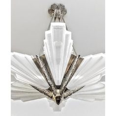 an art deco chandelier in the shape of a bird with wings on it