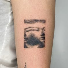 a woman's arm with a tattoo on the left side of her body and an image of a man