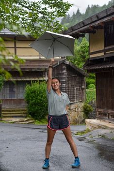 a woman holding an umbrella over her head