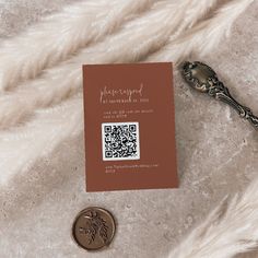 a close up of a piece of paper and a coin on a furry surface with a keychain