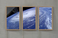 three pictures hanging on the side of a wall with an airplane flying over them in space