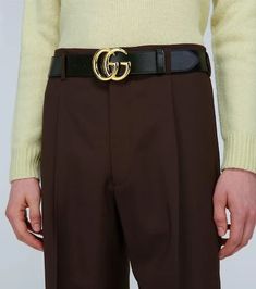 Enhance your look with this iconic Gucci leather belt. Crafted in Italy, it features supple calf leather and polished gold hardware for a timeless, luxury aesthetic. The coveted double G buckle logo ensures all eyes will be on your outfit. Thanks to adjustable punch holes, it effortlessly pairs with everything from jeans to suits. A lifestyle staple that elevates any 'fit for Instagram, this must-have belt brings classic GG style to your collection. Gucci Black Belt Buckles With Removable Belt, Gucci Designer Leather Belt, Modern Gucci Leather Belt Buckles, Designer Business Belts With Gold Buckle, Gucci Designer Belt Buckles For Business, Designer Leather Belt Buckles With Gold Buckle, Gucci Leather Belt Buckle With Removable Belt, Elegant Black Gucci Belt Buckles, Luxury Gucci Leather Belt