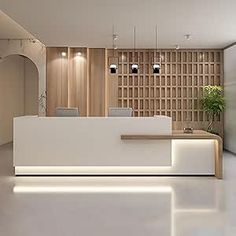 a white reception desk in an office with wood paneling and lighting on the walls