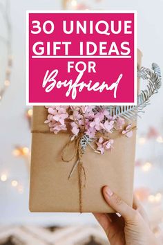 someone holding up a gift box with pink flowers on it and the words 30 unique gift ideas for boyfriend