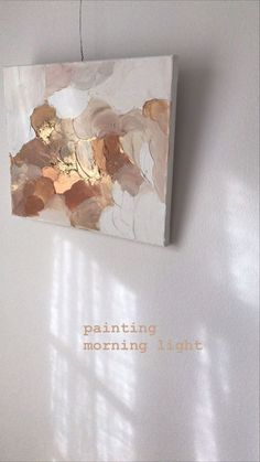 a piece of art hanging on the wall with words written below it that reads painting morning light