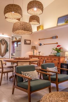 a living room filled with furniture and lots of lights hanging from the ceiling above it