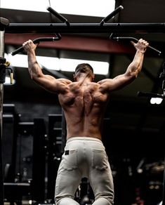 a man doing pull ups in the gym