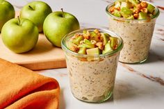 two cups filled with oatmeal, apples and nuts