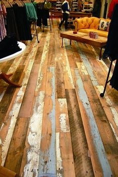 the inside of a clothing store with wooden floors