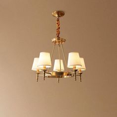 a chandelier with five lamps hanging from it