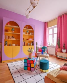 a living room filled with furniture and pink walls