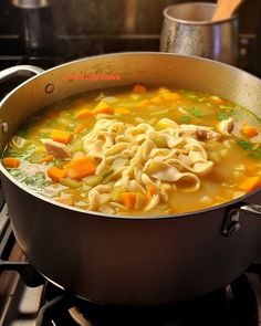 a pot filled with soup sitting on top of a stove