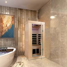 a bath room with a large tub and a painting on the wall above it's glass doors