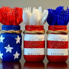 four patriotic mason jars with toothbrushes in them