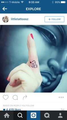 a person with a small elephant tattoo on their left hand and the other hand is pointing up