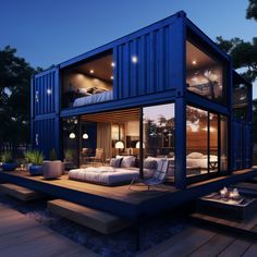 a large blue shipping container house sitting on top of a wooden deck next to a bed