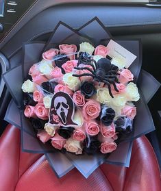 a bouquet of roses and spider on the dashboard of a car, decorated with fake flowers