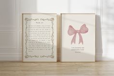 two framed pictures with pink bows on them in front of a white wall and wooden floor