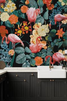 flamingos and tropical flowers on a black wallpaper in a kitchen with white sink