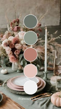 a table topped with plates and flowers next to a candle