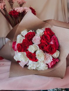 a bouquet of red and white flowers on a table