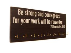 a sign that says be strong and courageous, for your work will be rewarded