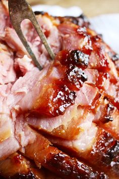 a fork is stuck into some meat on a plate