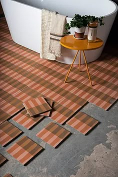 a bath tub sitting on top of a tiled floor