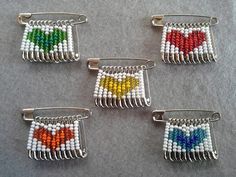 four pieces of beaded hair clips with hearts on them